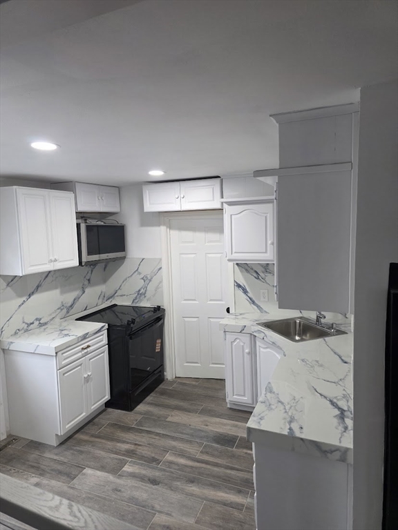 6 French Street, Unit AA Billerica, MA 01821 - Photo 5 of 16 a kitchen with stainless steel appliances granite countertop a sink stove and refrigerator