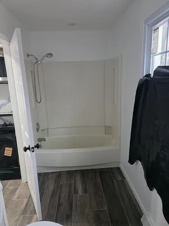 a bathroom with a bathtub and shower