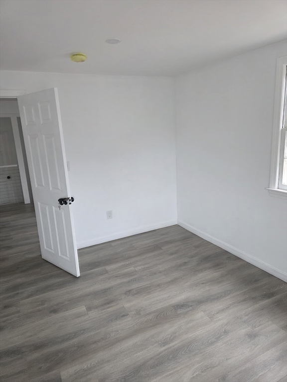 6 French Street, Unit AA Billerica, MA 01821 - Photo 9 of 16 wooden floor in an empty room with a window