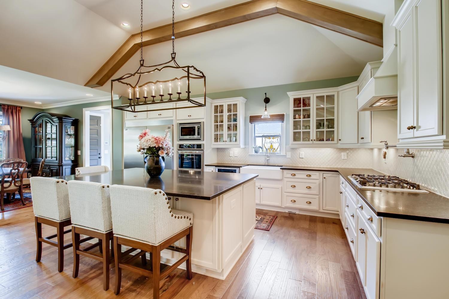 127 Vanner Road Mount Juliet, TN 37122 - Photo 2 of 29 a kitchen with stainless steel appliances granite countertop a stove a sink dishwasher a dining table and chairs with wooden floor