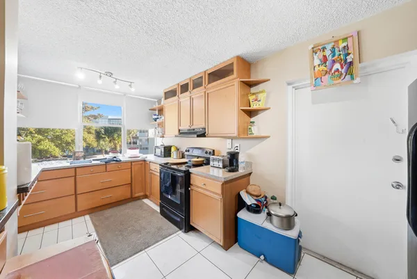 a kitchen with a refrigerator and window