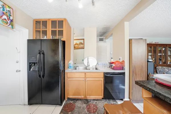 a kitchen with stainless steel appliances kitchen island granite countertop a refrigerator and a stove