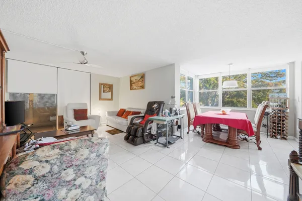 a living room with furniture a flat screen tv and a window