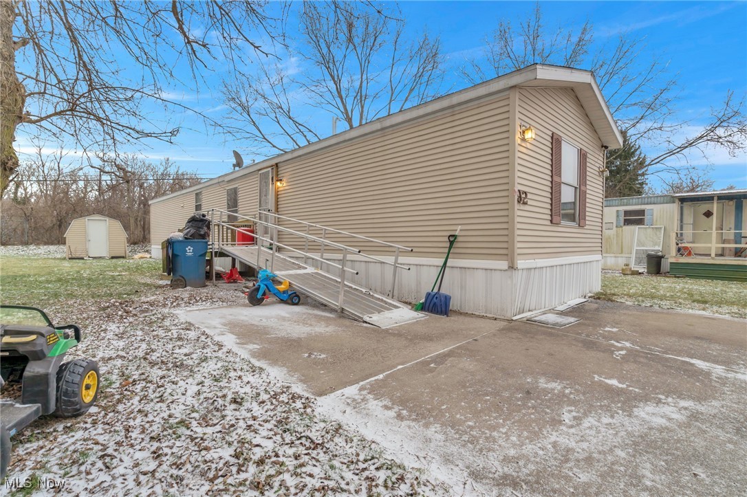 6615 Cleveland Road, Unit J2 Ravenna, OH 44266 - Photo 1 of 15 View of home's exterior featuring a shed