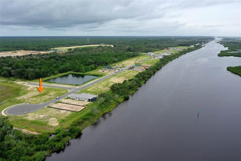 153 Coronado Road Flagler Beach, FL 32136 - Photo 1 of 19 a view of a lake with a city