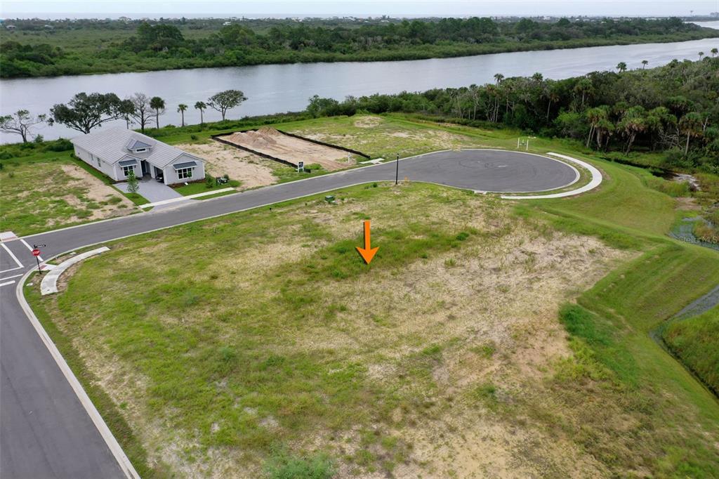 153 Coronado Road Flagler Beach, FL 32136 - Photo 3 of 19 a view of a lake with a yard and large trees