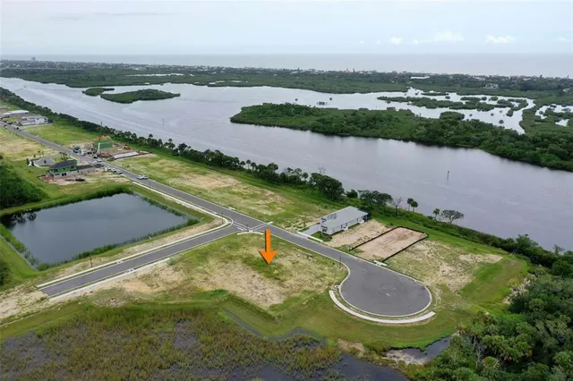 an aerial view of a house with a swimming pool and outdoor seating