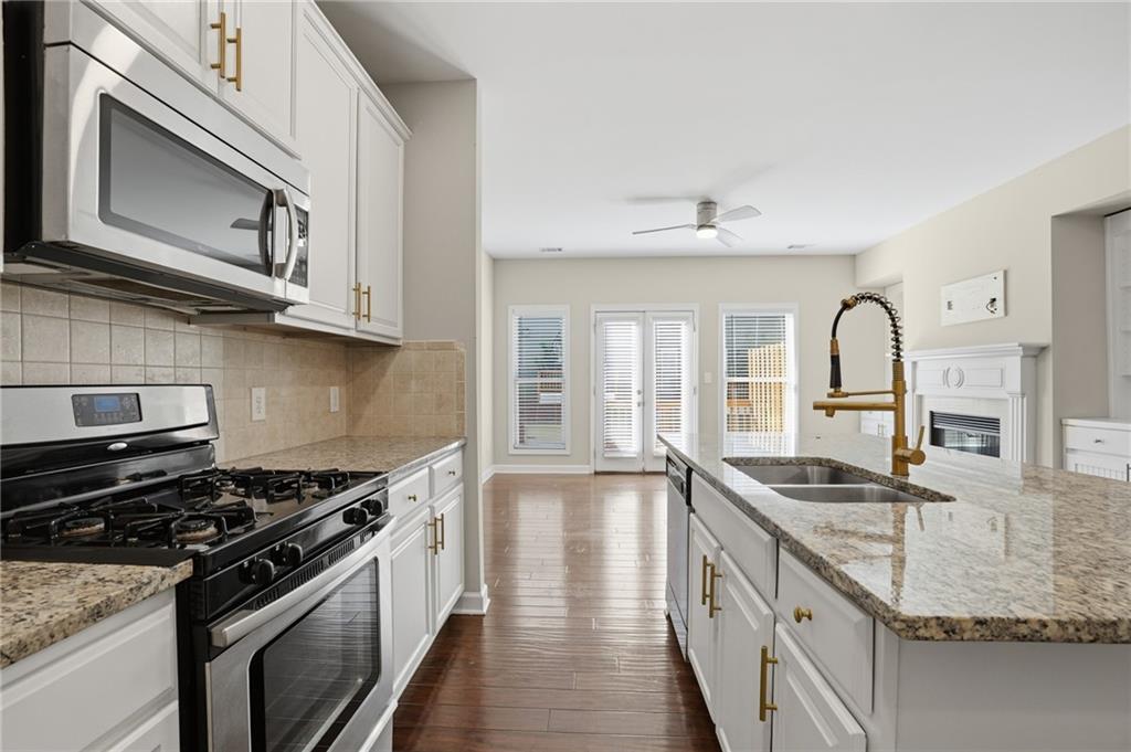 1221 Lavista Road Northeast Atlanta, GA 30324 - Photo 12 of 31 a kitchen with granite countertop stainless steel appliances a sink stove and cabinets