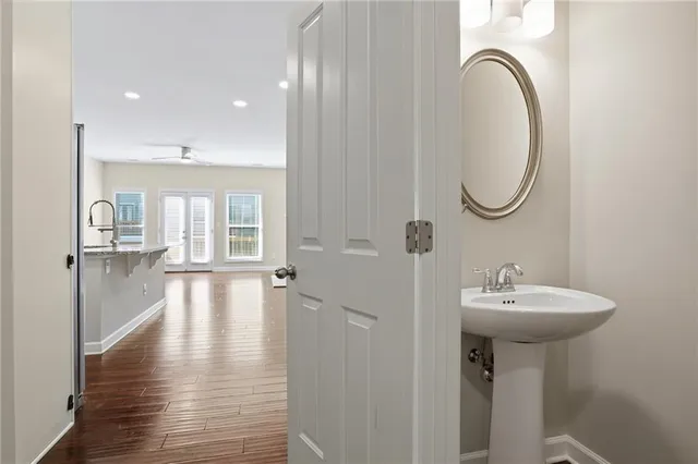 a bathroom with a sink shower and a mirror