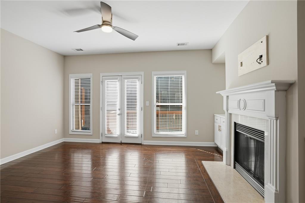 1221 Lavista Road Northeast Atlanta, GA 30324 - Photo 16 of 31 a view of empty room with wooden floor and fireplace