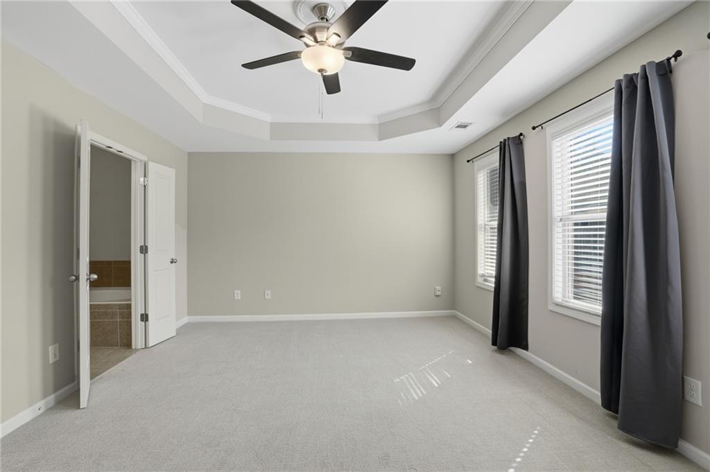 1221 Lavista Road Northeast Atlanta, GA 30324 - Photo 21 of 31 an empty room with chandelier fan and windows