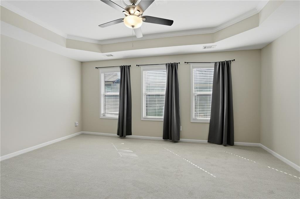 1221 Lavista Road Northeast Atlanta, GA 30324 - Photo 22 of 31 an empty room with chandelier fan and windows