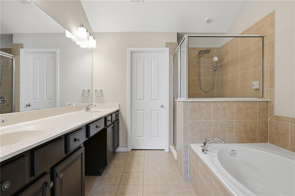 1221 Lavista Road Northeast Atlanta, GA 30324 - Photo 23 of 31 a bathroom with a tub sink shower and mirror