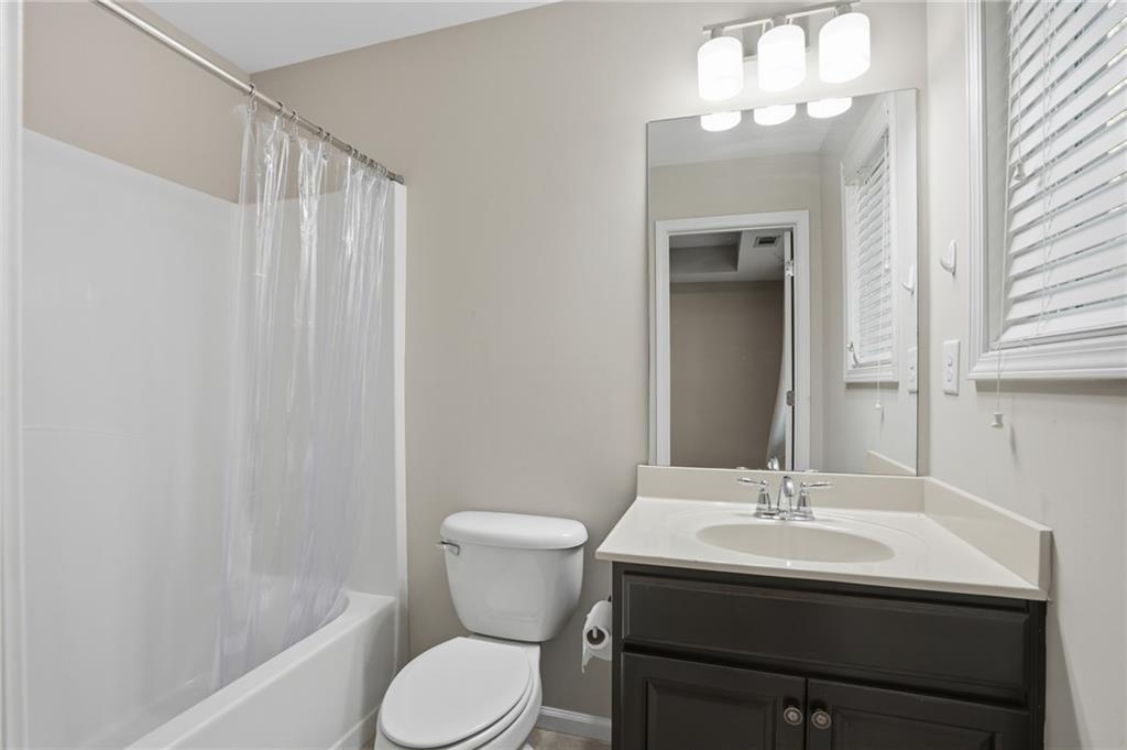 1221 Lavista Road Northeast Atlanta, GA 30324 - Photo 27 of 31 a bathroom with a sink toilet a mirror and shower