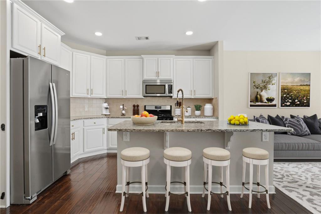 1221 Lavista Road Northeast Atlanta, GA 30324 - Photo 9 of 31 a kitchen with stainless steel appliances cabinets a dining table and chairs
