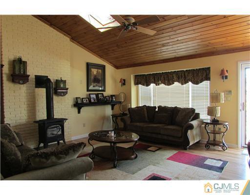 60 Club House Road Brick, NJ 08723 - Photo 2 of 23 a living room with furniture and a flat screen tv