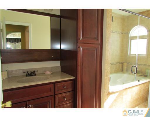 60 Club House Road Brick, NJ 08723 - Photo 11 of 23 a bathroom with a sink and a mirror
