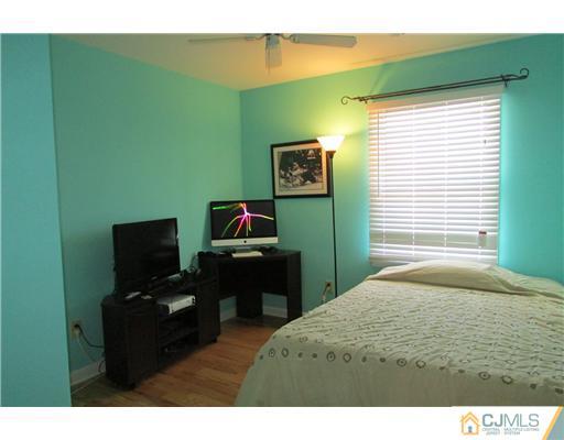 60 Club House Road Brick, NJ 08723 - Photo 12 of 23 a bedroom with a bed and a flat screen tv