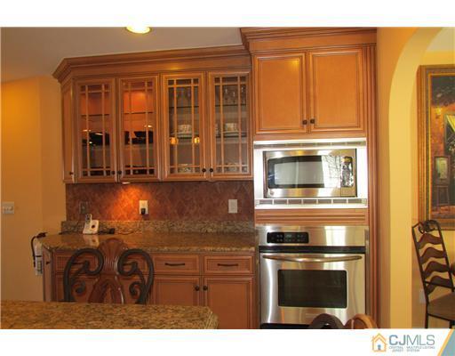 60 Club House Road Brick, NJ 08723 - Photo 5 of 23 a kitchen with stainless steel appliances granite countertop a stove and a microwave