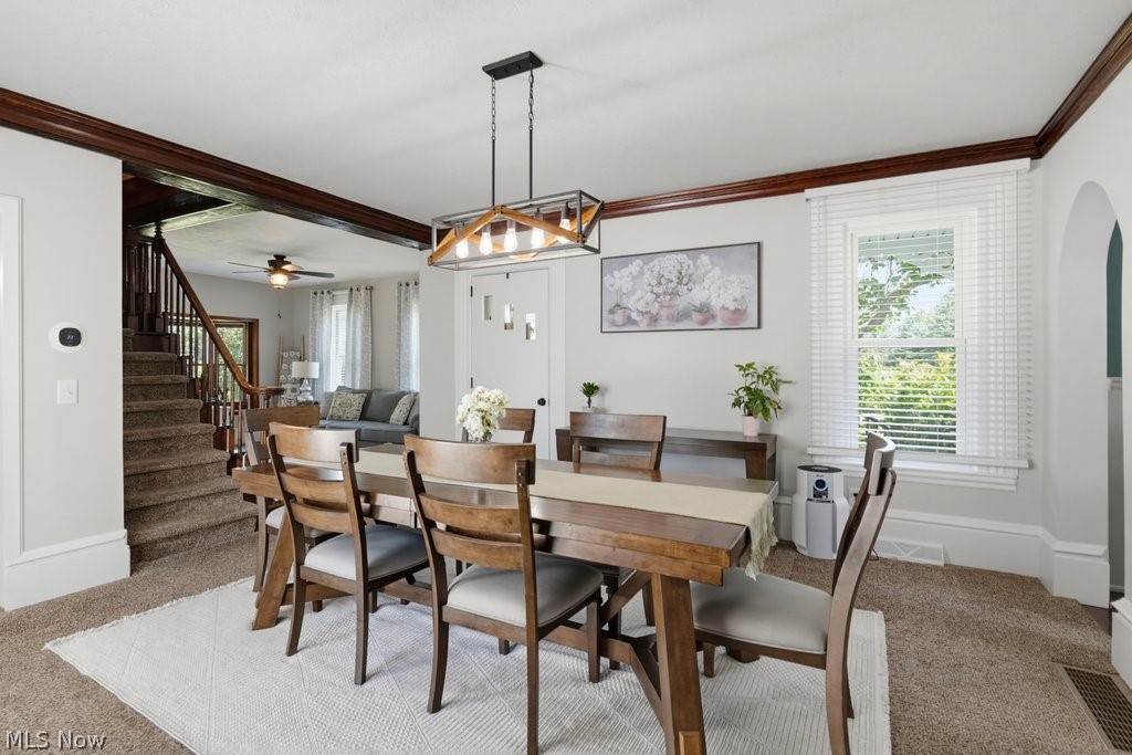 23055 Snell Road Columbia Station, OH 44028 - Photo 19 of 50 Dining area with a contemporary linear chandelier, white window blinds, and an arched doorway