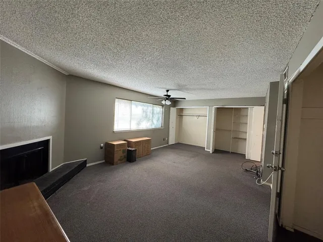 an empty room with windows and cabinet