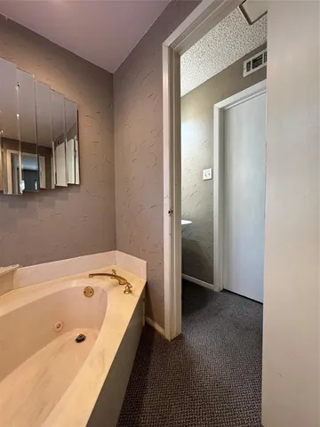 a bathroom with a tub and a shower