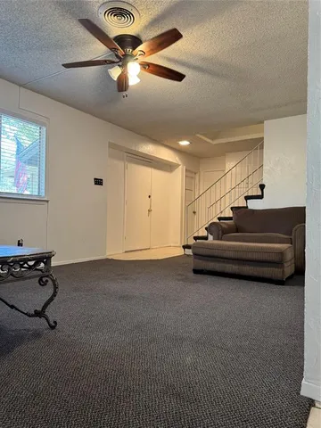 a spacious bedroom with a bed and a chandelier