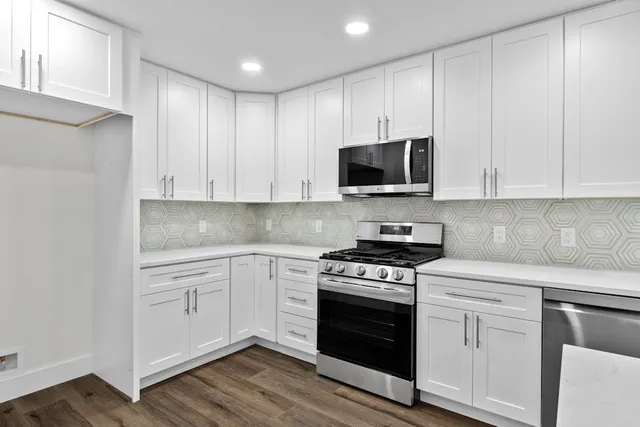 a kitchen with cabinets stainless steel appliances and a sink