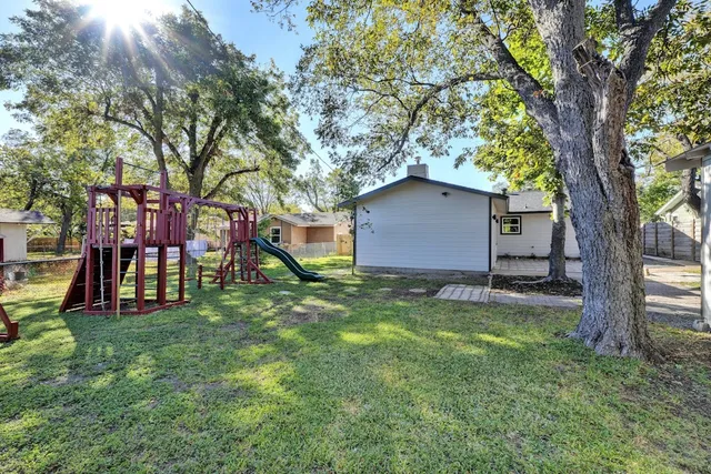 a house that has a tree in front of it