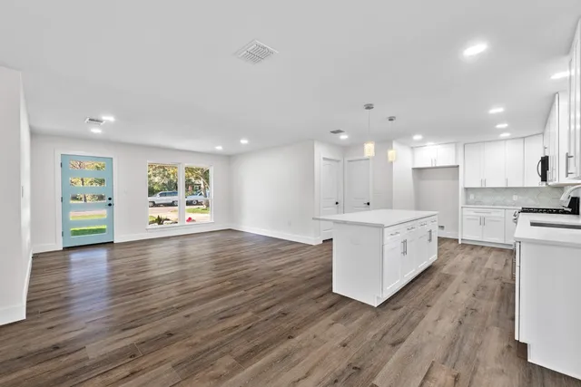 a view of kitchen with refrigerator and wooden floor