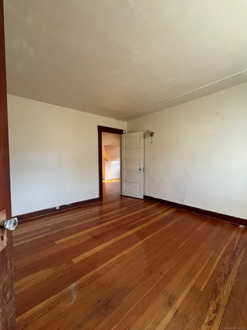 a view of an empty room and wooden floor