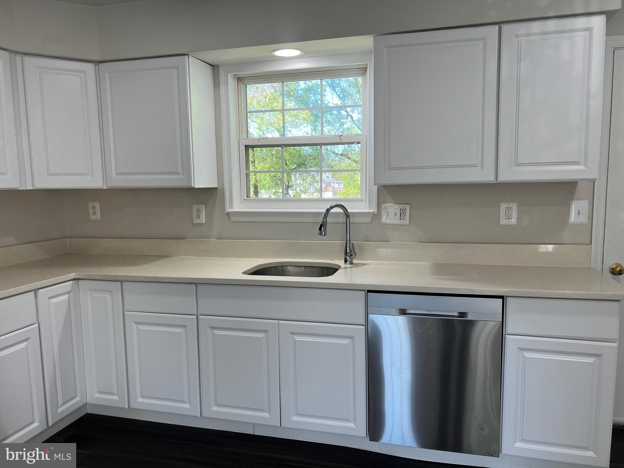 6604 Suitland Road Suitland, MD 20746 - Photo 18 of 27 a kitchen with white cabinets and sink