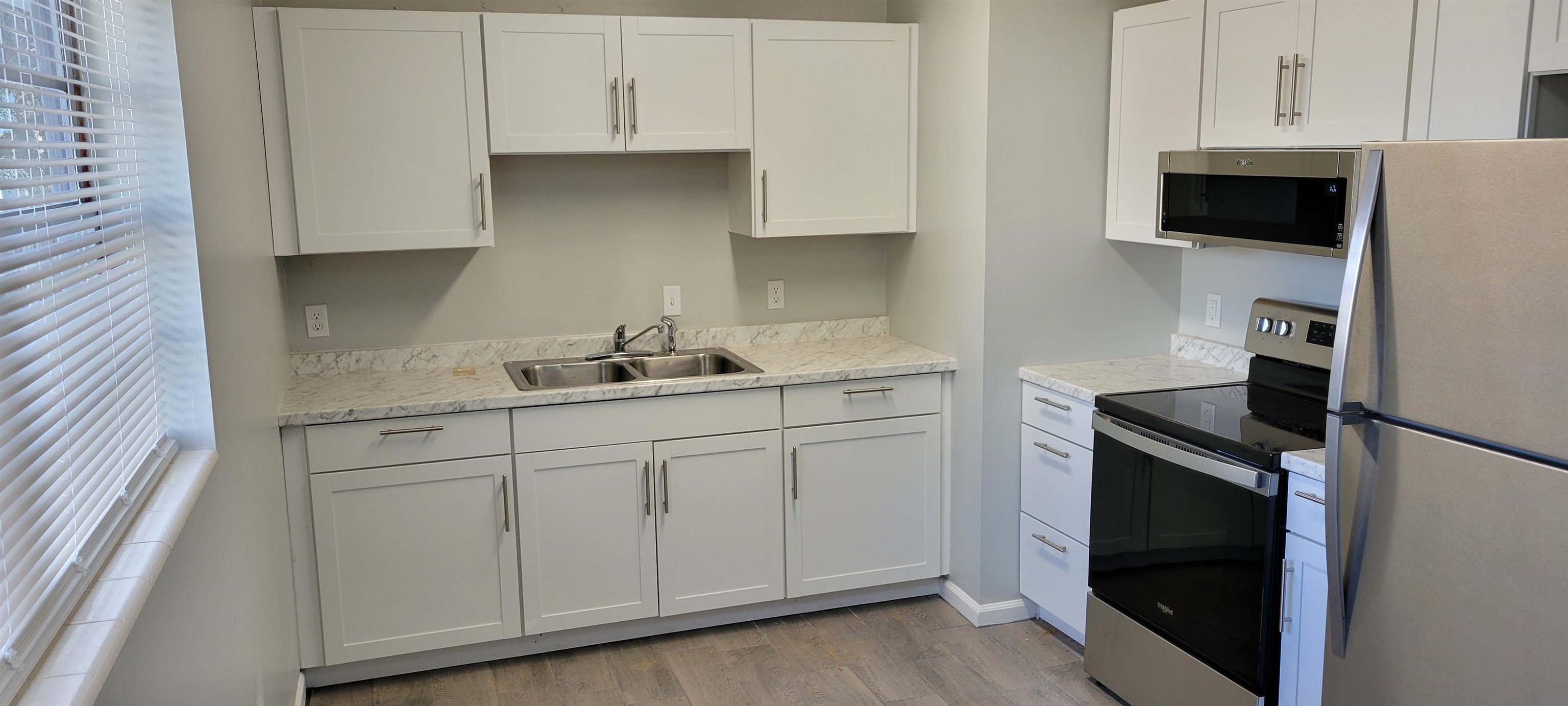 3 Travis Lane St. Augustine, FL 32084 - Photo 19 of 22 a kitchen with white cabinets and black appliances