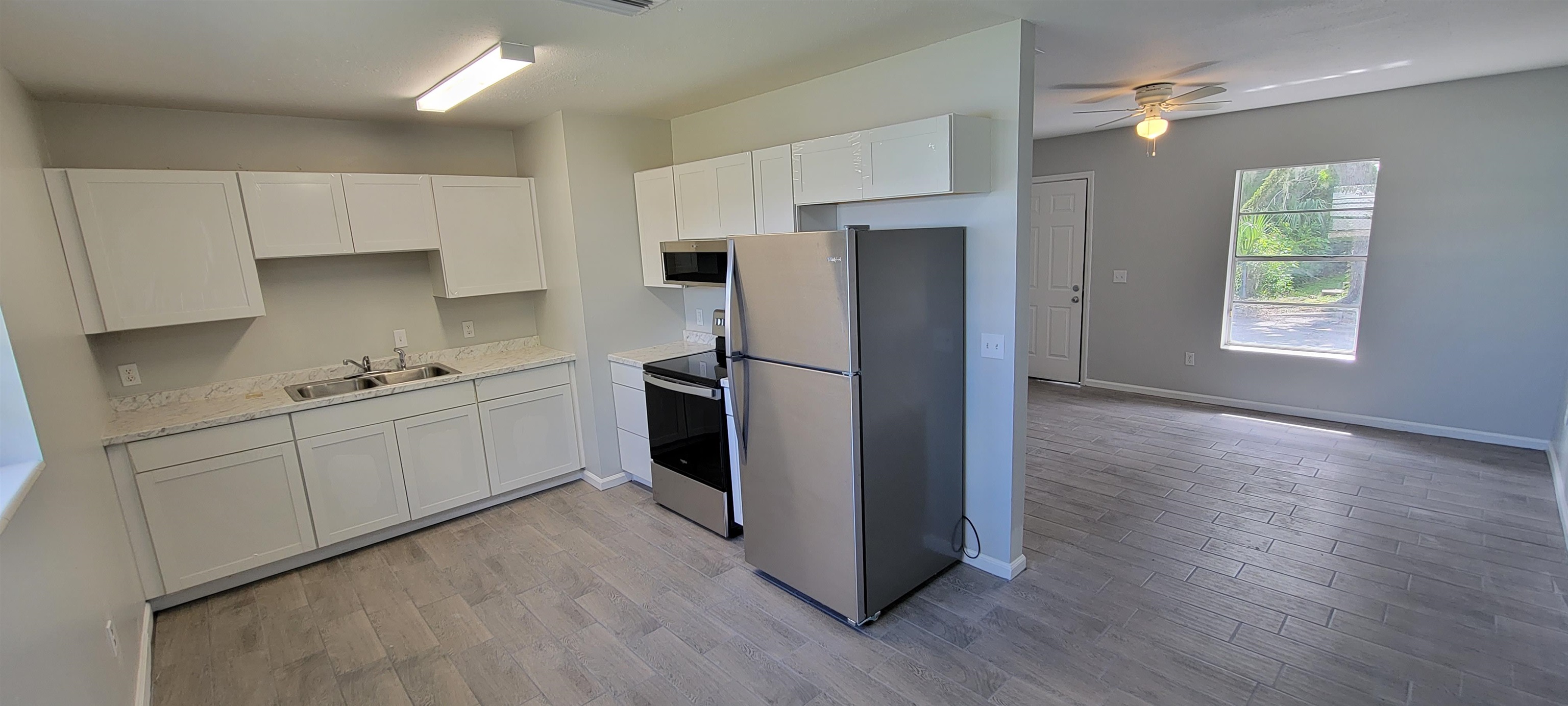 3 Travis Lane St. Augustine, FL 32084 - Photo 5 of 22 a kitchen with stainless steel appliances a refrigerator sink and cabinets