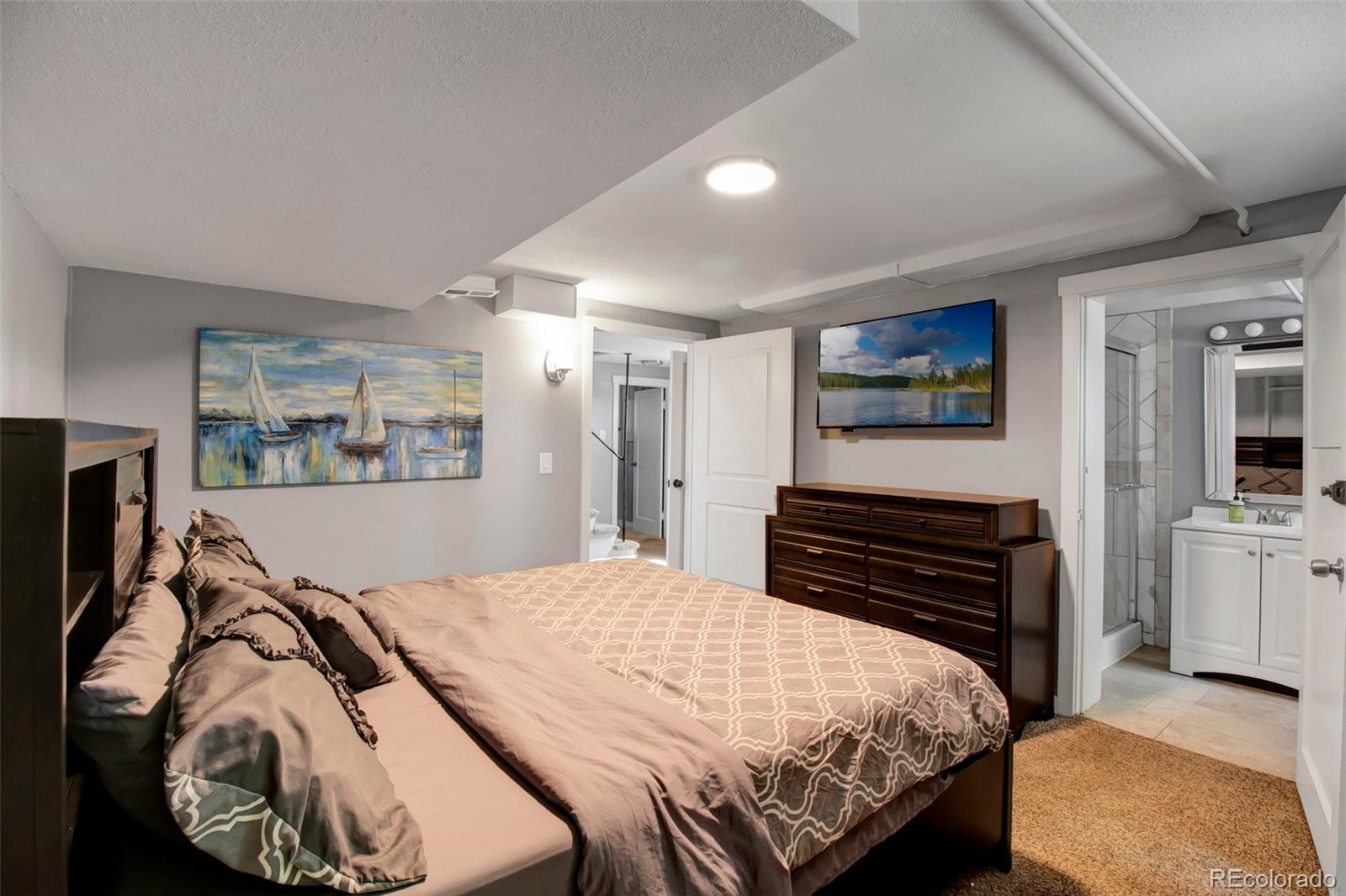 4737 Lowell Boulevard Denver, CO 80211 - Photo 12 of 28 a bedroom with a bed and dresser