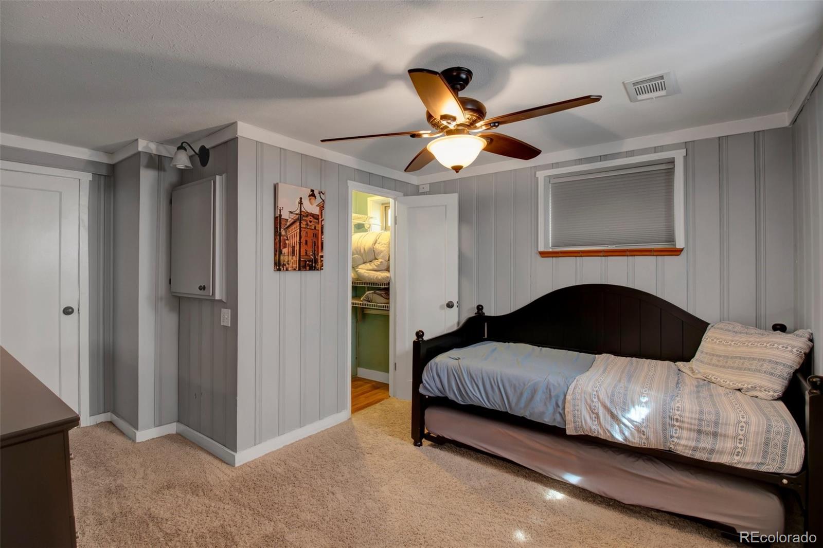 4737 Lowell Boulevard Denver, CO 80211 - Photo 14 of 28 a bedroom with a bed ceiling fan and a window