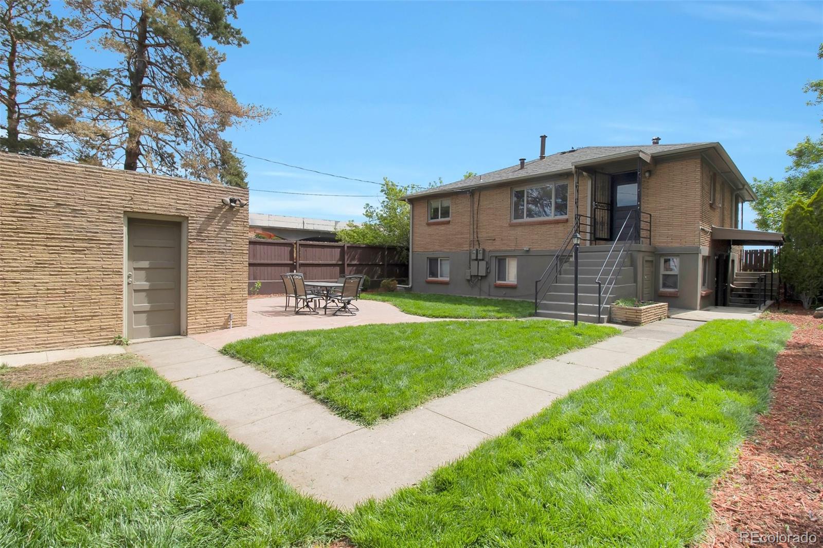 4737 Lowell Boulevard Denver, CO 80211 - Photo 16 of 28 a front view of a house with a yard and garage