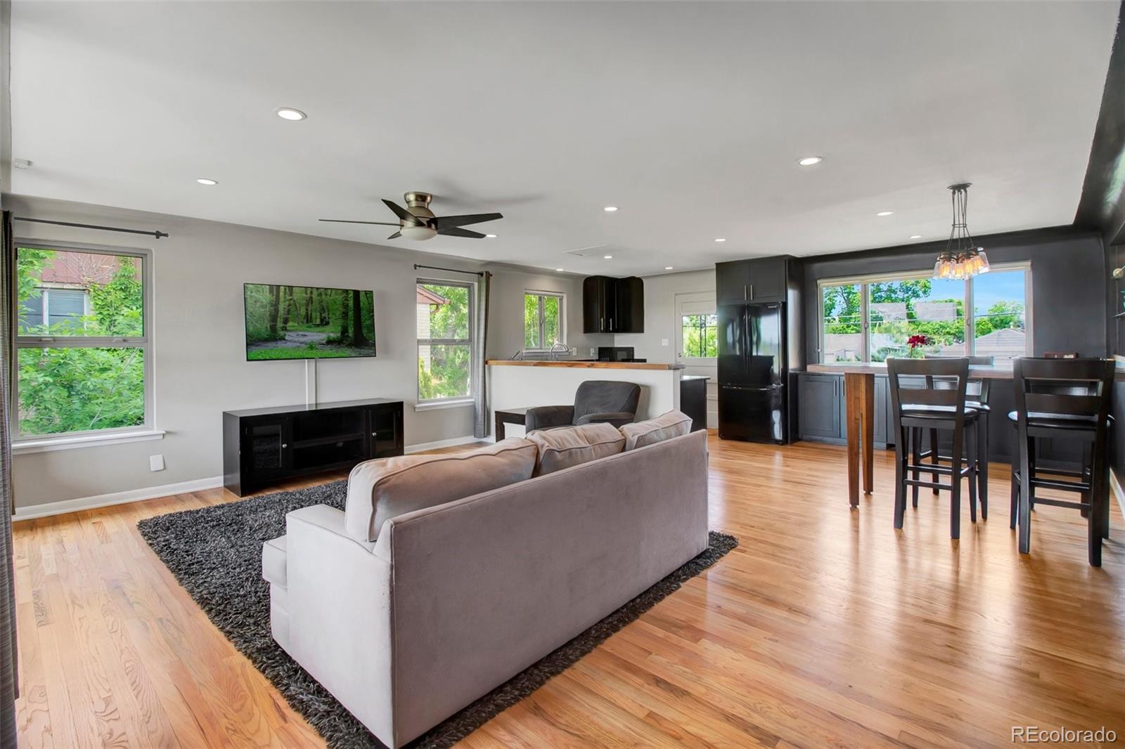 4737 Lowell Boulevard Denver, CO 80211 - Photo 2 of 28 a living room with furniture a fireplace and a flat screen tv