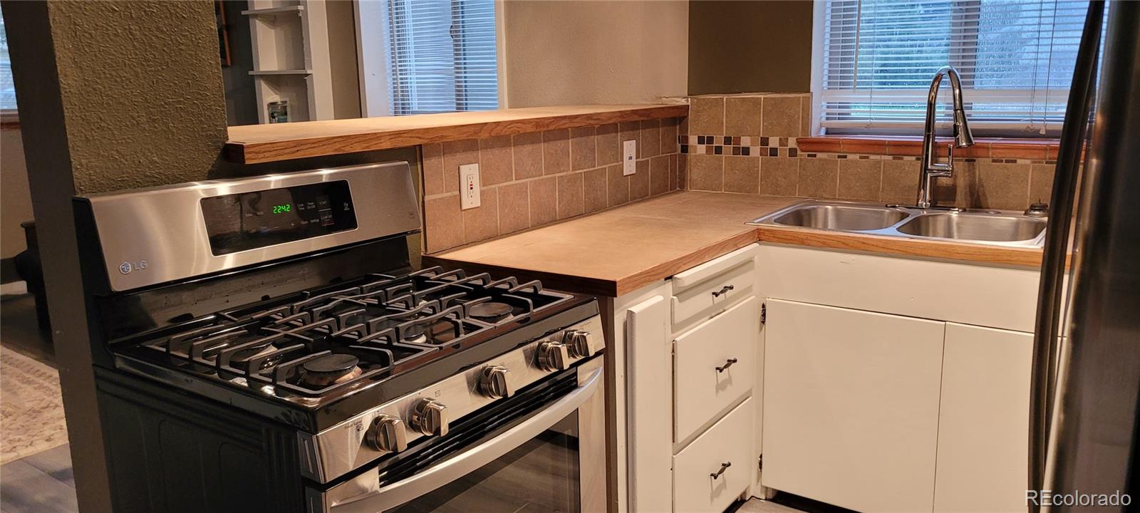 4737 Lowell Boulevard Denver, CO 80211 - Photo 24 of 28 a stove top oven sitting inside of a kitchen