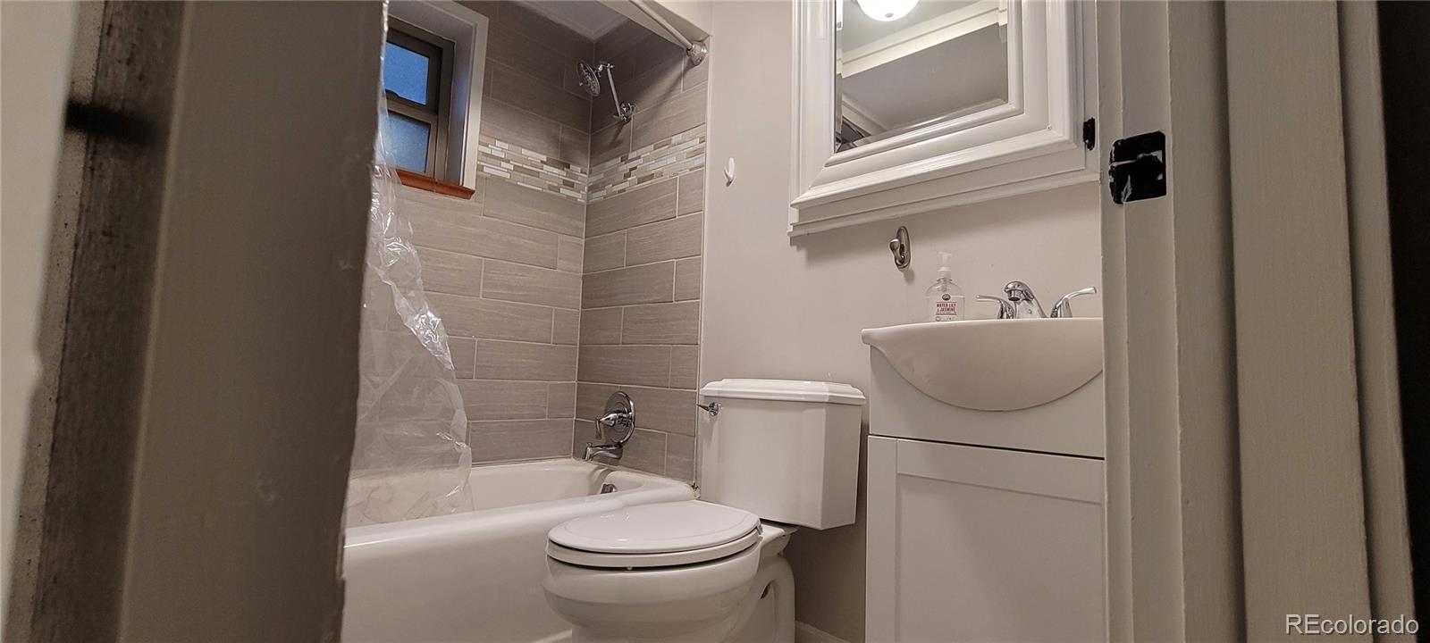 4737 Lowell Boulevard Denver, CO 80211 - Photo 26 of 28 a bathroom with a sink toilet and shower