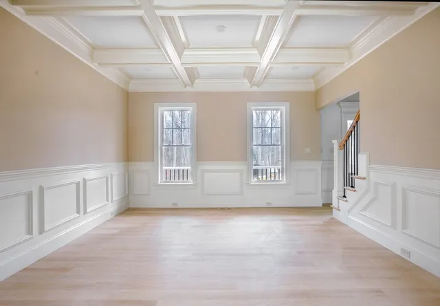 a view of staircase with railing and white walls