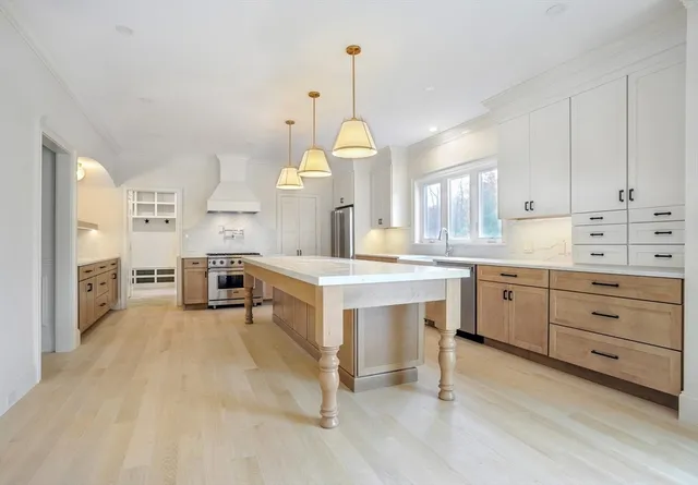 a large white kitchen with cabinets