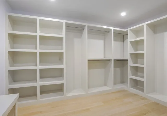 a spacious bathroom with a double vanity sink a mirror and a bathtub