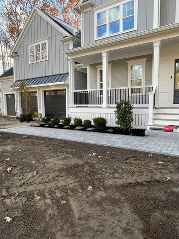 a view of a house with a yard and sitting area