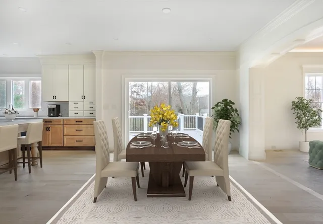 a view of a dining room with furniture and a potted plant