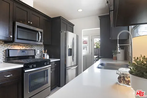 a kitchen with a refrigerator stove and microwave
