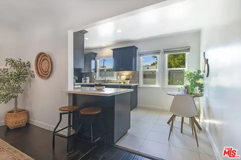 a kitchen with a dining table and chairs