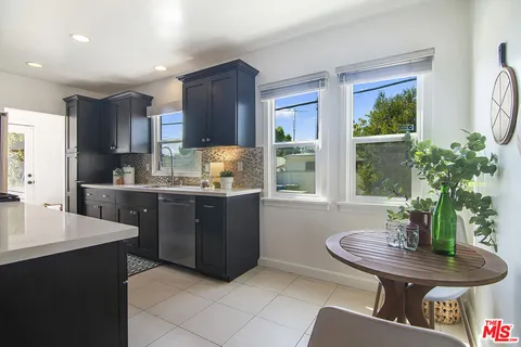 a kitchen with a table and chairs
