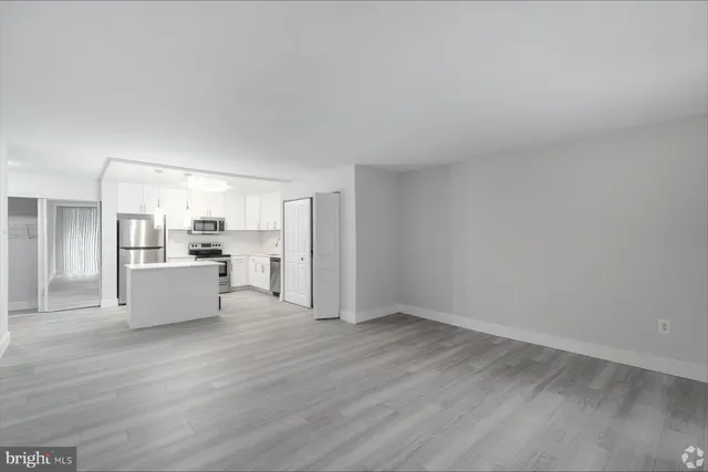 a view of kitchen with refrigerator sink and cabinets