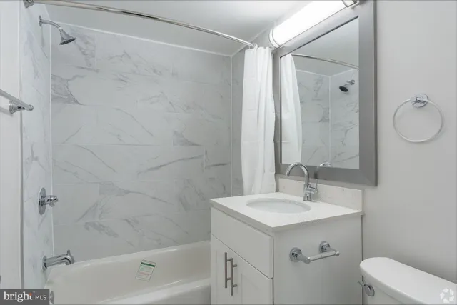 a bathroom with a sink mirror vanity and toilet